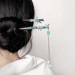 Bamboo style hair sticks with green faux jade and long metallic tassels on black hair