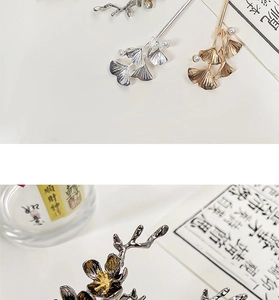 Close-up of vintage metal flower hairpins with ginkgo leaf and pearl details