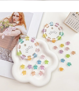 Set of mini flower hair claws in colorful jelly glitter tones on a white tray