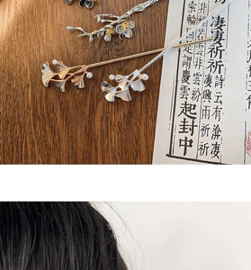 Close-up of vintage metal flower hairpins with gingko leaf and pearl accents