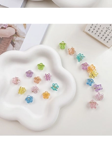 Mini flower hair claws in jelly macaron colors displayed on a white petal tray