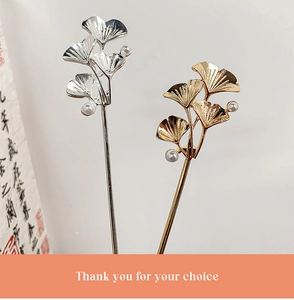 Detail of vintage ginkgo leaf hairpins with white pearls in gold and silver finish