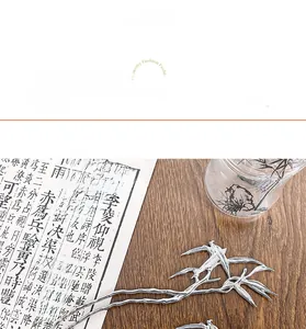 Detailed macro shot of silver bamboo leaf hair pin with natural metallic texture