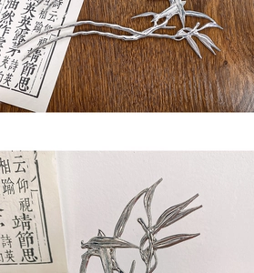 Detailed macro view of silver alloy bamboo leaf hair pin with elegant metallic texture