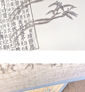Detail of silver bamboo leaf hairpin with dual-prong design on calligraphy paper