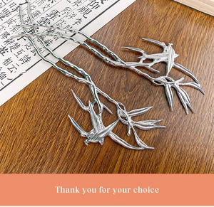Detail of silver bamboo leaf hairpins with metallic texture on traditional paper