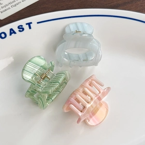 Three-piece set of marble patterned acetate claw clips in pastel blue green and pink