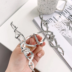 Silver metallic shark hair clip with abstract geometric lines and glossy finish