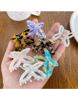 Close-up of small acetate butterfly hair claws in various marble and tortoiseshell patterns