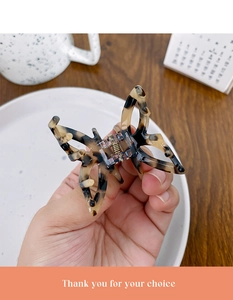 Detail of tortoise shell acetate butterfly hair claw clip with golden metal spring
