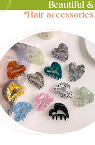 Flat lay of heart-shaped acetate hair claws in various marble and leopard patterns