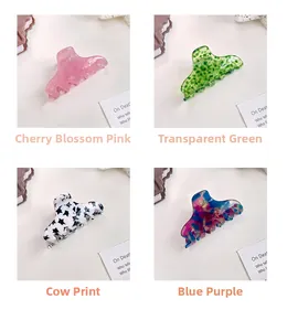 Detailed grid of acetate hair claws in cherry pink, green floral, cow print, and blue purple