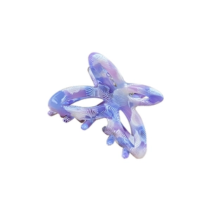 Elegant small acetate butterfly hair claw clip with blue and purple marble wave patterns