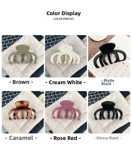 Detail showing various colors of large hair claw clips including matte and glossy finishes