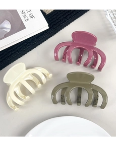 Three large glossy resin hair claws in berry purple, cream white, and olive green colors