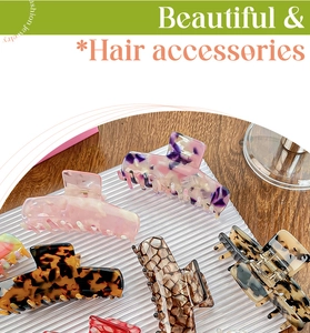 Detail showing a collection of large acetate hair claws with various marble and floral patterns