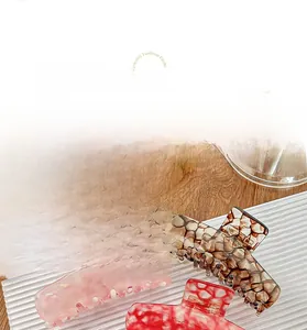 Three-piece set of large acetate hair claws in pink, brown honeycomb, and marble patterns