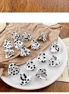 Detailed set of 12 mini heart acetate hair clips with black star pattern for side styling