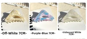 Three 7cm hollow geometric acetate claw clips in cream white, blue and iridescent white