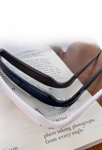 Close-up of glossy square sunglasses headband in black, ivory white, and deep brown