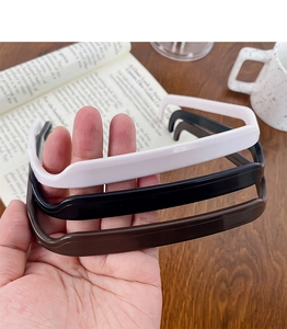 Close-up of square sunglasses-style headbands in white, black and brown glossy finishes