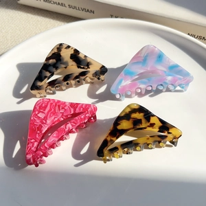 Minimalist geometric acetate claw clips in four marble patterns on white tray