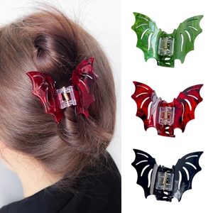 Gothic bat wing hair claw clips in red, green, and black marble acetate for Halloween styling