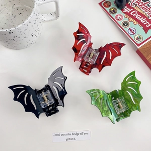 Gothic bat-shaped hair claws in red, black, and green colors for Halloween styling