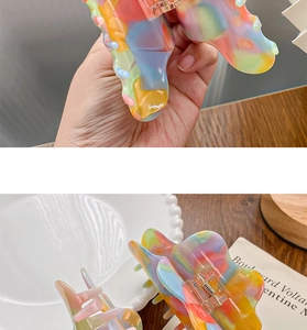 Detailed view of large colorful acetate hair claw clip with vibrant marbled pattern