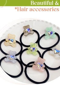 Close-up of candy color bear hair scrunchies with heart gemstones in a white display plate