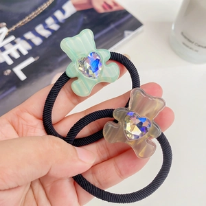 Green and grey gummy bear hair ties with heart crystals and black elastic ropes