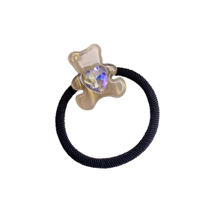 Candy-colored bear hair tie with translucent resin and sparkling heart-shaped gemstone