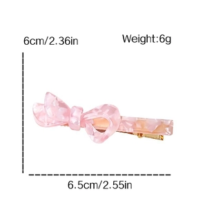 Fermaglio per capelli a fiocco in acetato rosa marmorizzato con molla in metallo oro