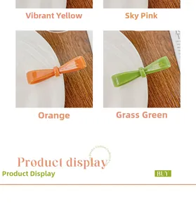 Detail showing colorful acetate bow hair clips with gold-tone France Handmade engraving