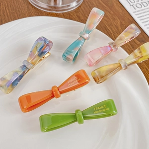 Handmade acetate bow hair clips in six vibrant colors with gold-toned metal duckbill clips
