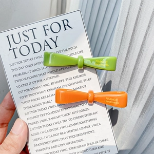 Vibrant green and orange acetate bow hair clips with France Handmade gold lettering