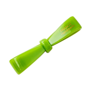 Neon green acetate bow hair clip with gold France Handmade lettering on a white background