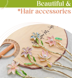 Detail of vintage metal lotus hairpins with enamel flowers and pearls on a fan
