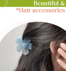 Close-up of translucent light blue floral hair claw with iridescent finish on model