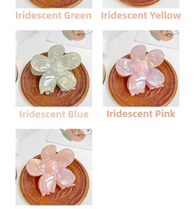 Close-up of floral hair claws in pearlescent green, yellow, cyan and pink colors
