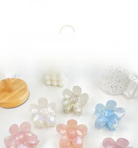 Macro detail of acetate flower hair claw clip with iridescent pearlescent finish