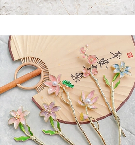 Detail of vintage Chinese lotus hair pin with enamel floral petals and pearl accents