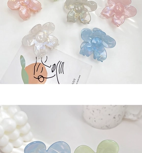 Detail of floral acetate hair claw clips with iridescent finish in multiple soft colors
