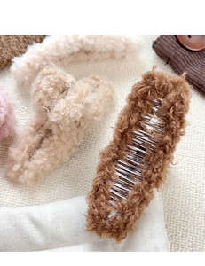 Détail de pinces à cheveux en peluche douce aux tons chauds de marron et beige