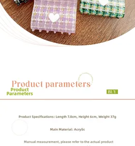 Detail view of purple and green checkered acrylic hair claw with white heart ornament