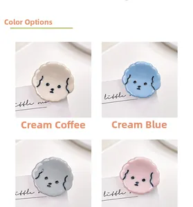 Detail of four colorful mini puppy hair clips in cream, blue, gray and pink resin finish