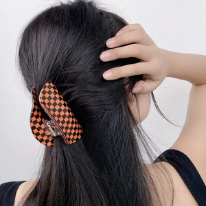 Halloween checkerboard hair claw clip in orange and black for women back hair styling
