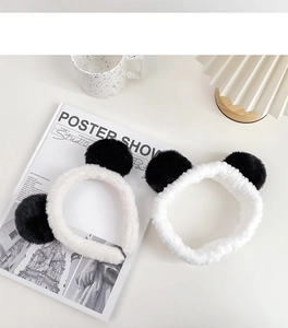 Close-up of fluffy white panda ears headband and elastic hair band set in soft plush fabric