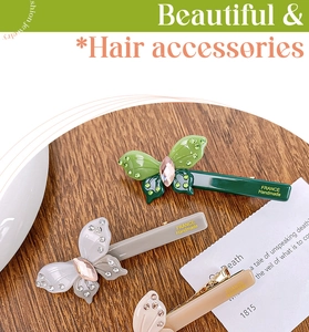 Detail of acetate butterfly hair clips with rhinestones and France Handmade text
