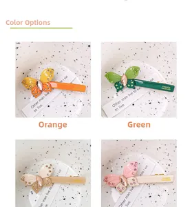 Detailed close-up of acetate butterfly hair clips with crystals and France Handmade stamp